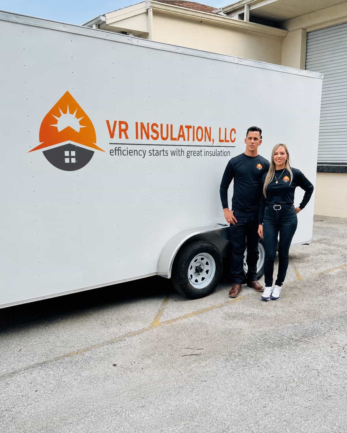 The founders of VR Insulation beside the company's branded trailer
