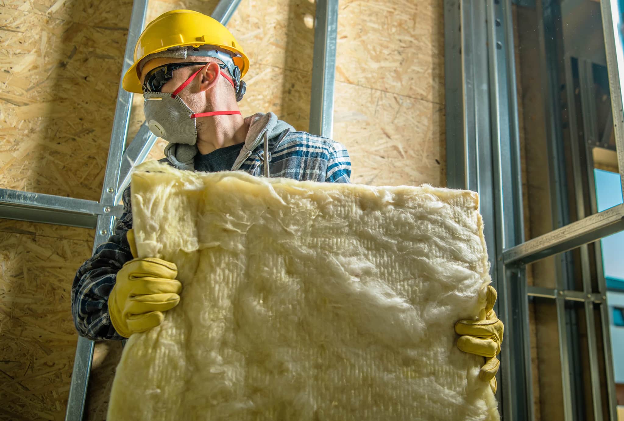 The VR Insulation team in front of the company sign listing its services